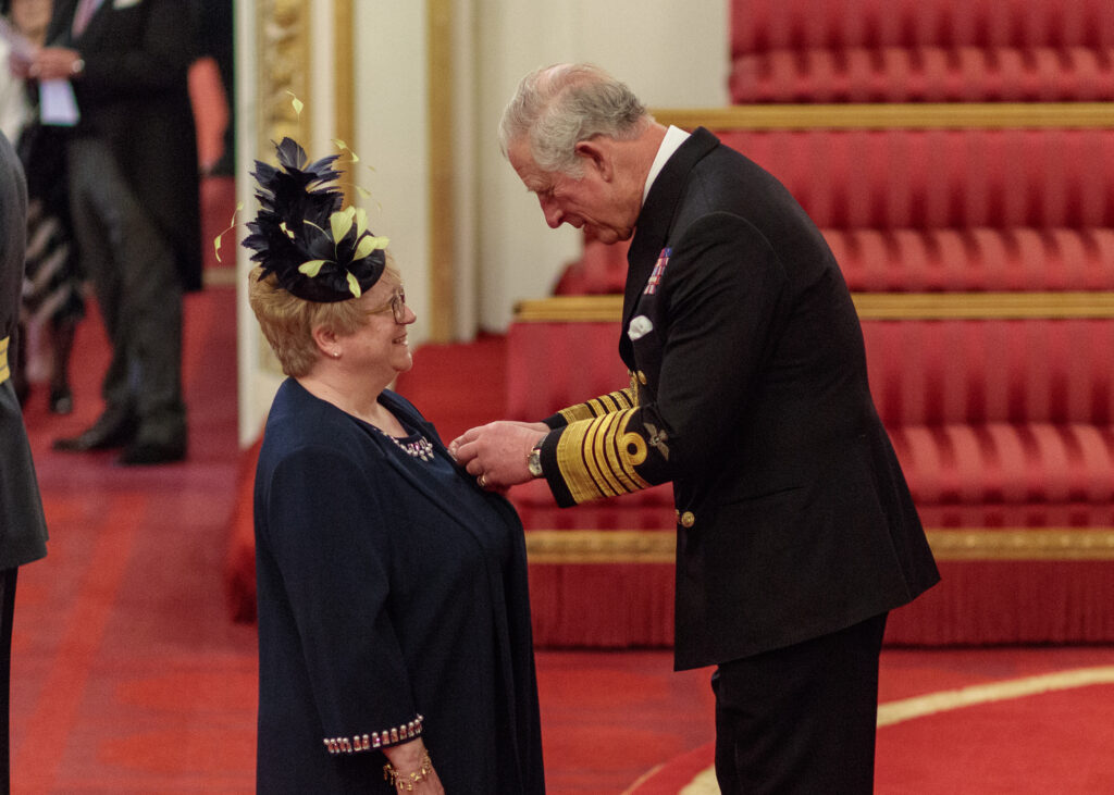 Debbie Gardiner being presented with her MBE by Prince Charles at Buckingham Palace